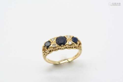 A SAPPHIRE AND DIAMOND RING the three graduated circular-cut sapphires are set with four single-
