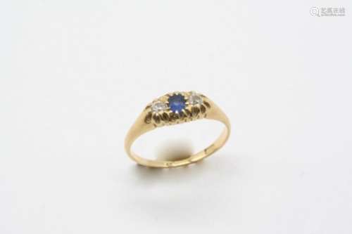 A SAPPHIRE AND DIAMOND THREE STONE RING the circular-cut sapphire is set with two circular-cut