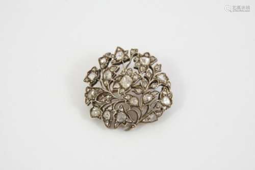 A VICTORIAN DIAMOND BROOCH of openwork foliate form, the centre flowerhead mounted with a cushion-