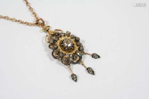 A VICTORIAN DIAMOND PENDANT the flowerhead design is centred with an oval rose-cut diamond and