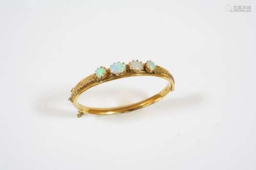 AN OPAL AND GOLD HALF HINGED BANGLE the 15ct. gold bangle set to one side with two oval-shaped and