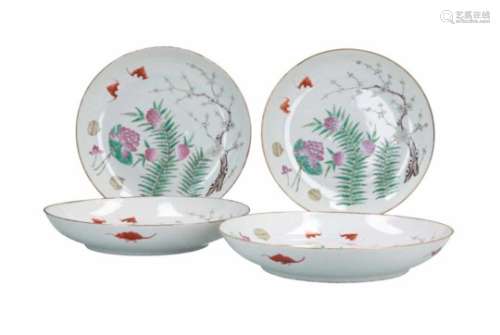A set of four polychrome porcelain dishes, decorated with bats, flowers and fruits. Marked with seal