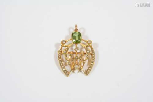 AN EDWARDIAN PERIDOT AND PEARL SET PENDANT the openwork foliate design is set with a rectangular-