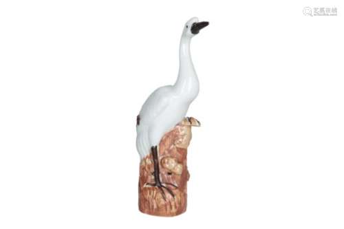 A polychrome porcelain sculpture of a bird. Marked with seal mark. China, 20th century. H. 29,5 cm.