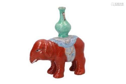 A polychrome porcelain sculpture of an elephant with a vase on his back. Unmarked. China, 19th/