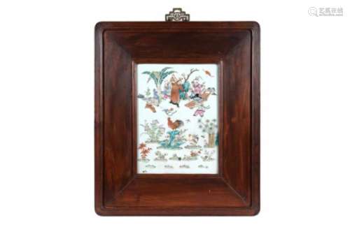 A polychrome porcelain plaque in wooden frame, depicting figures, a rooster, hen and chicks.