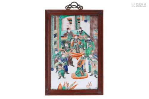 A polychrome porcelain plaque in wooden frame, depicting figures and a warlord. Unsigned. China,