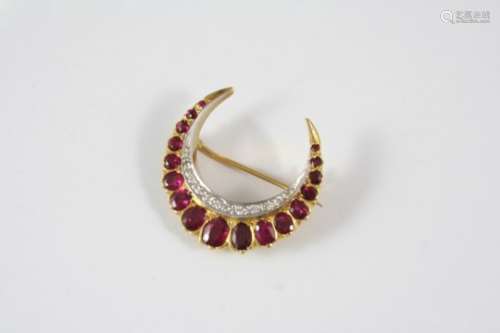 A RUBY AND DIAMOND CLOSED CRESCENT BROOCH mounted with graduated oval-shaped rubies and circular-cut