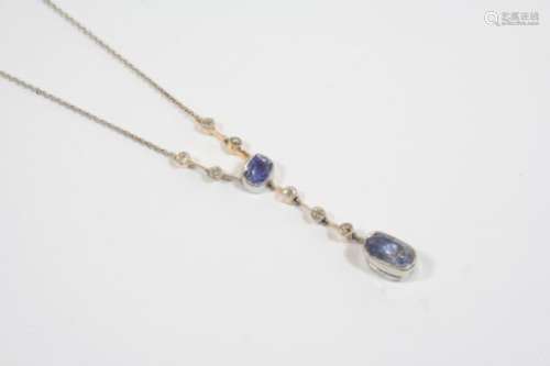 AN ART DECO SAPPHIRE AND DIAMOND PENDANT the two oval-shaped sapphires are suspended from knife edge