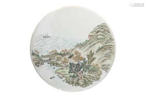 A round polychrome porcelain plaque, decorated with a mountainous river landscape. Unmarked.