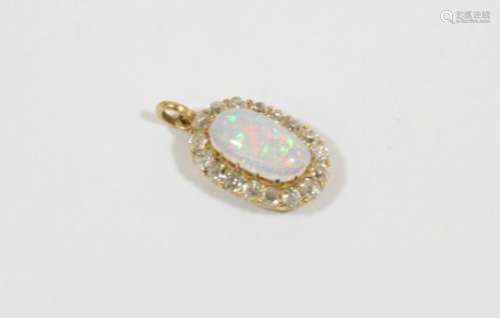 AN OPAL AND DIAMOND CLUSTER PENDANT the oval-shaped solid white opal is set within a surround of old
