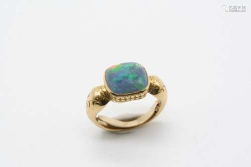 A BLACK OPAL SINGLE STONE RING the cushion-shaped solid black opal is mounted in an ornate