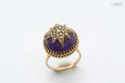 AN AMETHYST AND PEARL SET RING the circular cabochon amethyst is mounted with a half pearl set