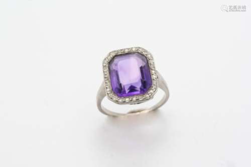 AN EARLY 20TH CENTURY AMETHYST AND DIAMOND CLUSTER RING the cut cornered rectangular-shaped amethyst