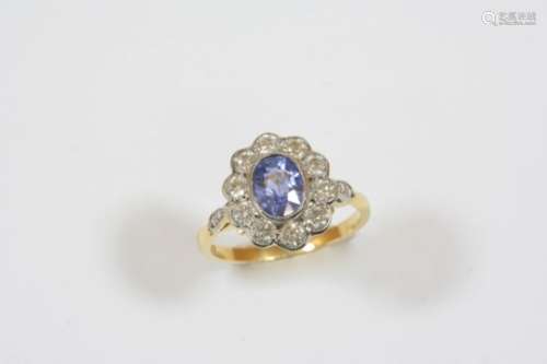 A SAPPHIRE AND DIAMOND CLUSTER RING the oval-shaped sapphire is set within a surround of ten