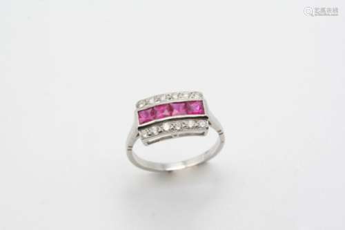 A RUBY AND DIAMOND THREE ROW RING the four calibre-cut rubies are set within a border of circular-