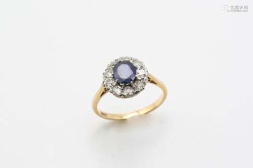 A SAPPHIRE AND DIAMOND CLUSTER RING the oval-shaped sapphire is set within a surround of old