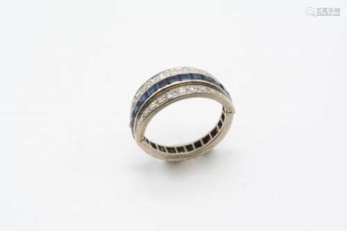 A SAPPHIRE, RUBY AND DIAMOND SWIVEL ETERNITY RING set with rectangular-shaped calibre-cut