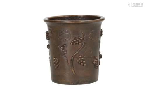 A bronze brush pot, decorated in relief with grape vines. Marked with 4-character mark. China,