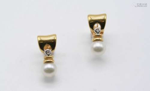 A PAIR OF DIAMOND AND CULTURED PEARL EARRINGS each 18ct. gold mount is set with a circular-cut