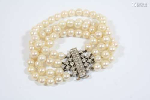 A DIAMOND AND CULTURED PEARL BRACELET formed with four rows of uniform cultured pearls measuring