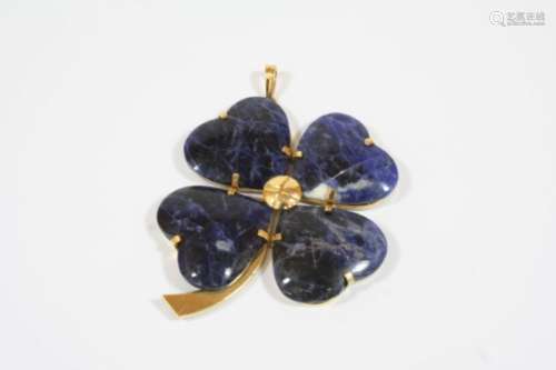 A SODALITE SHAMROCK PENDANT formed with four sections of sodalite, in gold, 6cm. wide.