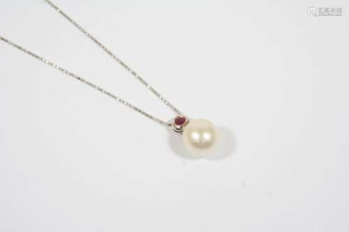 A SOUTH SEA PEARL AND RUBY PENDANT the pearl measures approximately 11.0mm., and is suspended from a