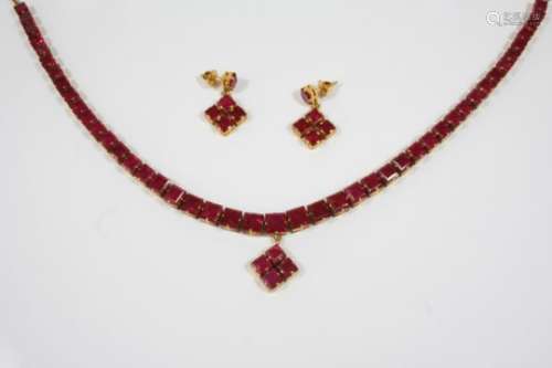 A RUBY AND GOLD NECKLACE mounted with forty five graduated square-shaped rubies in gold, on a gold