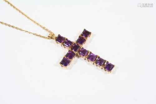 AN AMETHYST CRUCIFORM PENDANT formed with square-shaped amethysts, in 9ct. gold, on a 9ct. gold