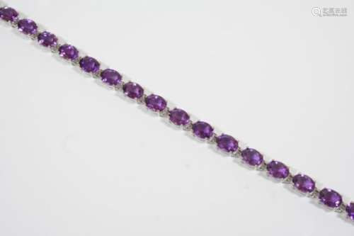 AN AMETHYST AND GOLD BRACELET the 18ct. gold bracelet is mounted with eighteen oval-shaped