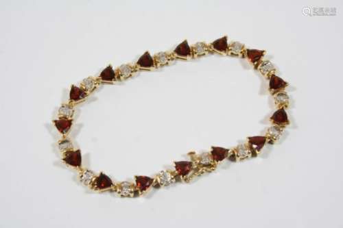 A GARNET AND DIAMOND BRACELET the 14ct. gold bracelet is mounted with triangular-shaped garnets