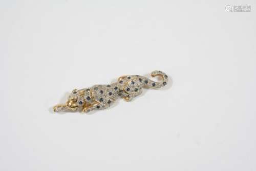 A DIAMOND AND SAPPHIRE LEOPARD BROOCH formed as a leopard lying down, set overall with circular-