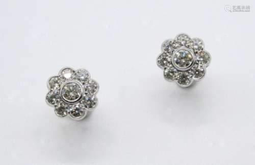 A PAIR OF DIAMOND CLUSTER STUD EARRINGS of flowerhead form, the circular-cut diamond is set within a