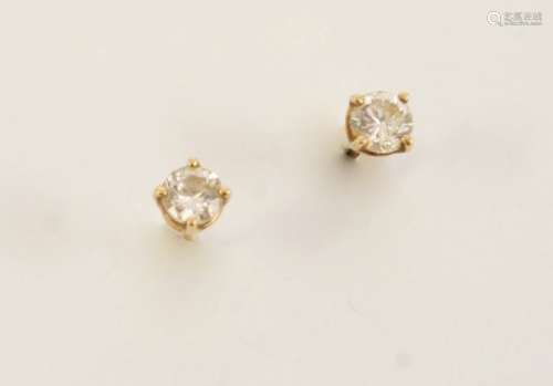 A PAIR OF DIAMOND STUD EARRINGS each set with a circular-cut diamond, in gold.