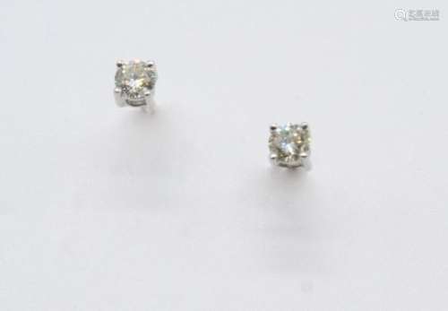 A PAIR OF DIAMOND STUD EARRINGS each set with a brilliant-cut diamond weighing approximately 0.33