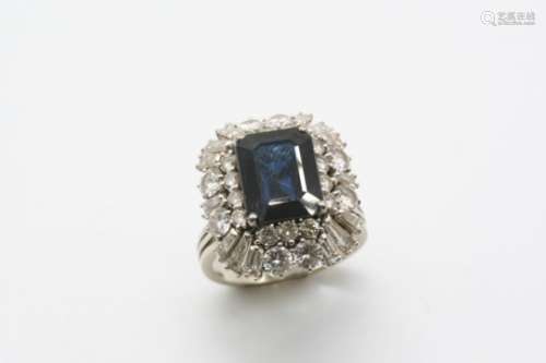 A SAPPHIRE AND DIAMOND CLUSTER RING the rectangular-shaped sapphire is set within a surround of