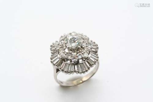 A DIAMOND CLUSTER RING the central circular-cut diamond is set within a double surround of