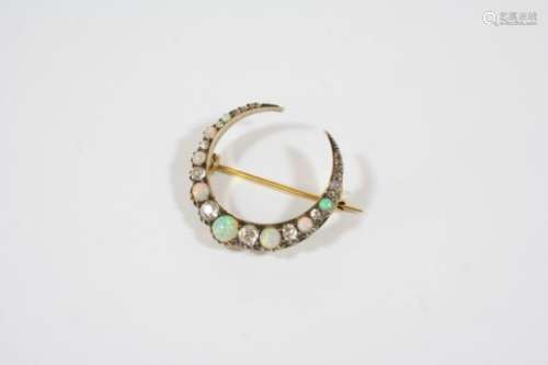 A VICTORIAN DIAMOND AND OPAL CLOSED CRESCENT BROOCH formed with graduated circular solid white opals