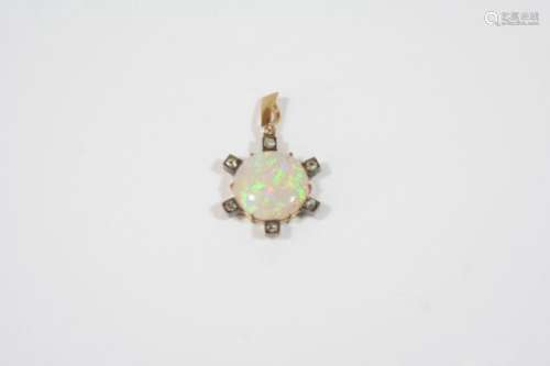 AN OPAL AND DIAMOND PENDANT the circular solid white opal is set within a gold surround mounted with