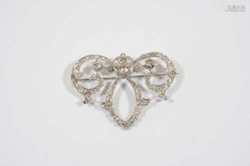 A DIAMOND BROOCH the openwork scrolling design is set with graduated circular-cut diamonds, 5cm.