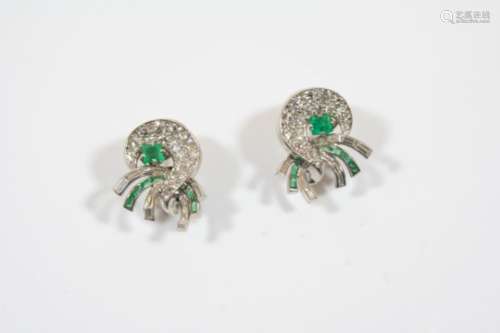 A PAIR OF DIAMOND AND EMERALD EARCLIPS BY J.E. CALDWELL of scrolling design, each mounted with a