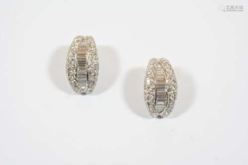 A PAIR OF DIAMOND HALF HOOP EARCLIPS each centred with a row of graduated baguette-cut diamonds