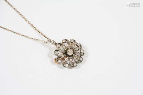 A VICTORIAN DIAMOND BROOCH PENDANT of flowerhead form and set overall with graduated old brillint-