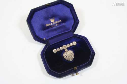 A VICTORIAN DIAMOND HEART-SHAPED BROOCH the diamond set heart is suspended from a row of graduated