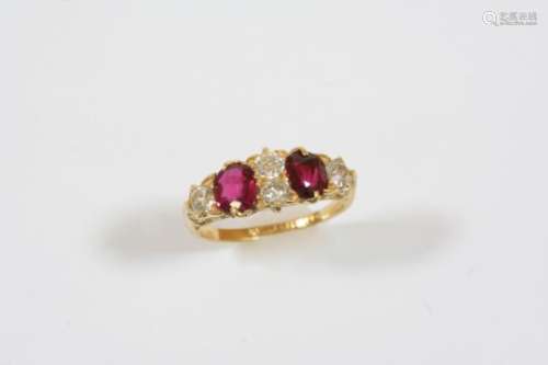 AN EARLY 20TH CENTURY RUBY AND DIAMOND RING the two oval-shaped rubies are set with four old