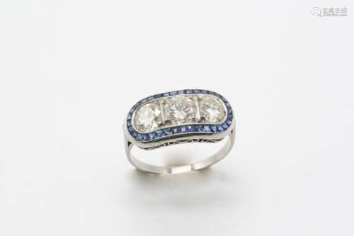 A SAPPHIRE AND DIAMOND RING centred with three brilliant-cut diamonds weighing 2.10 carats in