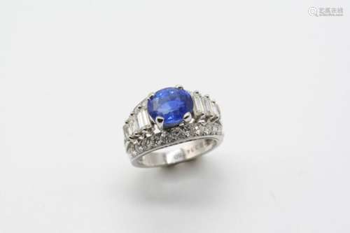 A SAPPHIRE AND DIAMOND RING the oval-shaped sapphire weighs 3.14 carats and is set within a surround