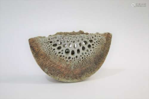 ALAN WALLWORK (BORN 1931) a thin stoneware wedge form vessel, with pierced holes on each side.