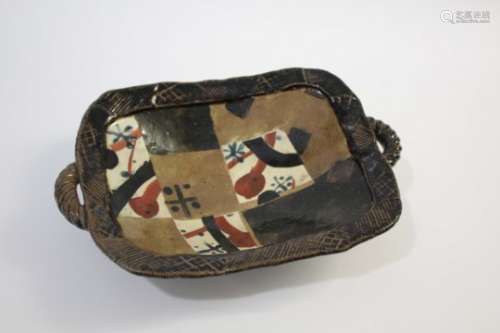 JOHN MALTBY (BORN 1936) a raised stoneware dish with a tenmoku glaze, the interior painted with
