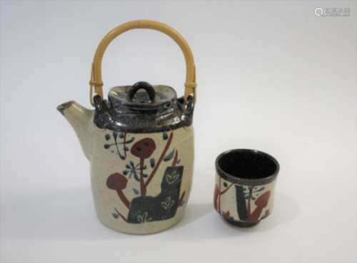 JOHN MALTBY (BORN 1936) a stoneware teapot of slender shape, painted with various motifs to both